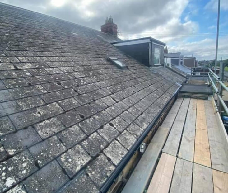 Aged slate roof requiring repair on a British period property